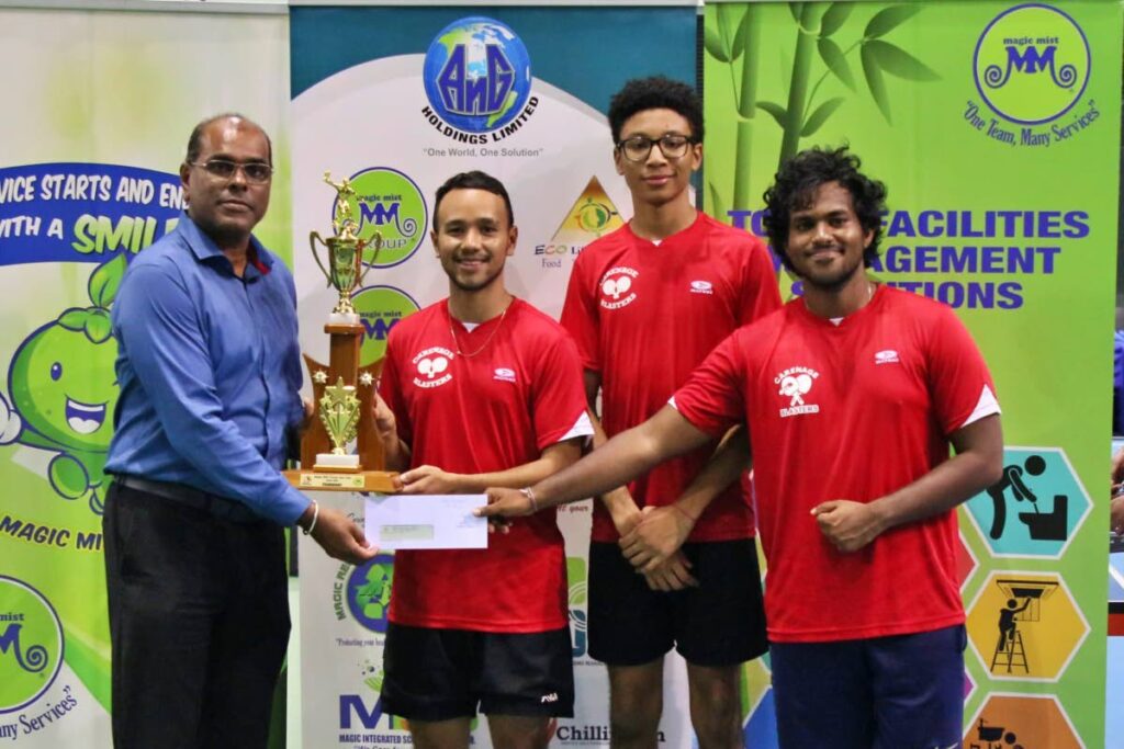 Carenage Blasters players are presented with the trophy and prize after winning the Magic Mist Group Table Tennis final on Thursday at the National Racquet Centre, Tacarigua. Photo courtesy Ernest Fraser, TTTTA - 