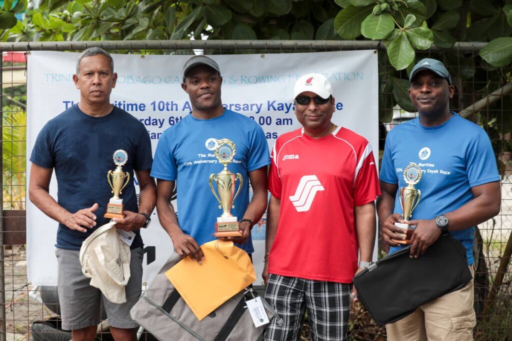 The Maritime 10th anniversary kayak race short course winner Akeem Chesney, second from left, with runner-up Rahsaan Hazelwood, right, third-placed Terrence Rampersadsingh, left, and Kia representative Akeem Chesney, at Williams Bay, Chaguaramas. - 