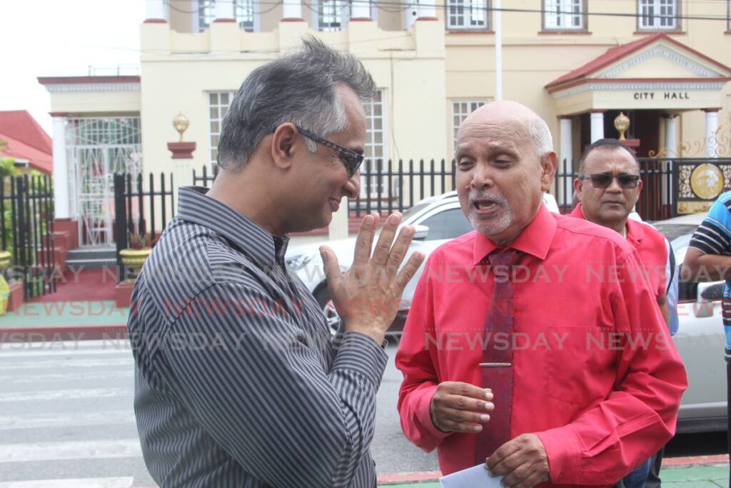 At left, Pundit Rudranath Maharaj greets Pastor Clive Dottin at the press conference held by the Concerned Cirtizens for a Better San Fernando held on Harris Promenade, San Fernando. - Photo by Lincoln Holder