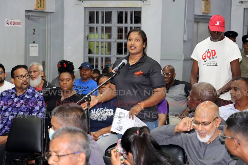 MY CONCERNS: Kamla Phagoo raises a point during a police town meeting on Wednesday evening at the Warrenville Regional Complex. PHOTO BY ROGER JACOB - 