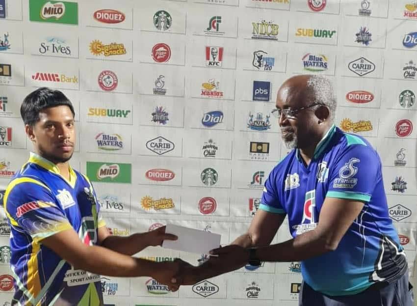 Pradeem Ali of Savannah Boys, left, collects the player of the match award from vice chairman of the North Zone Cricket Council Gregory Wales. - 