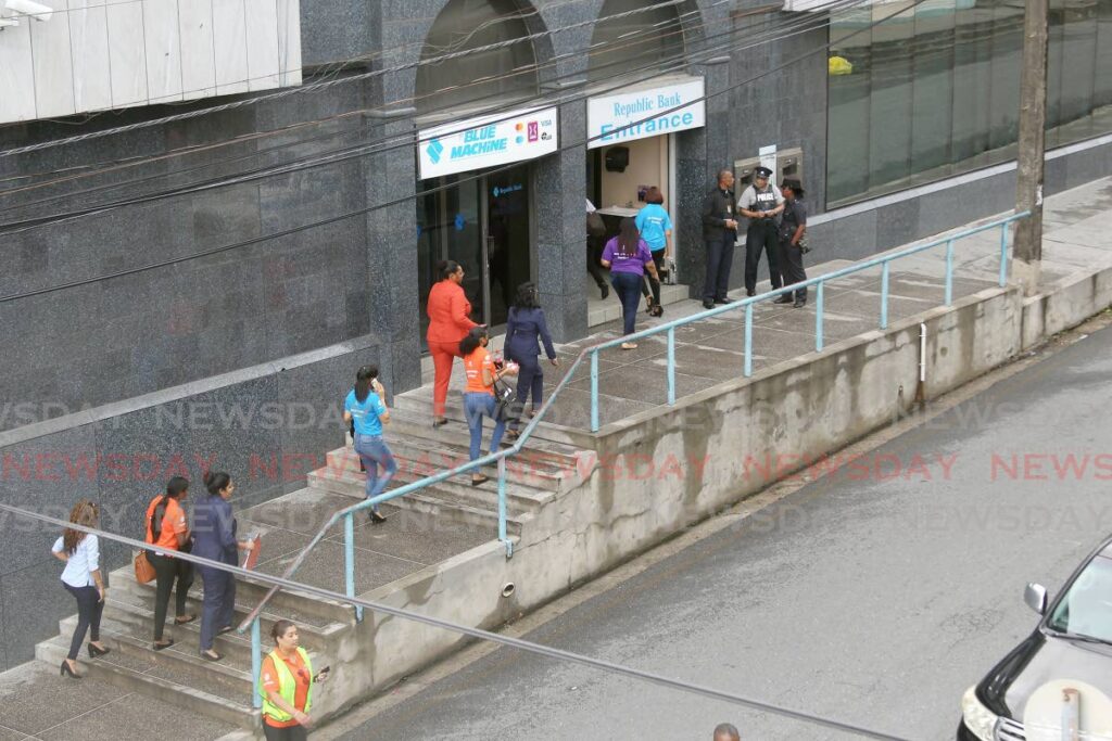 BACK TO WORK: Workers from Republic Bank's High Street branch return to work after police searched the premises after an e-mailed bomb threat on Friday. PHOTO BY LINCOLN HOLDER - 