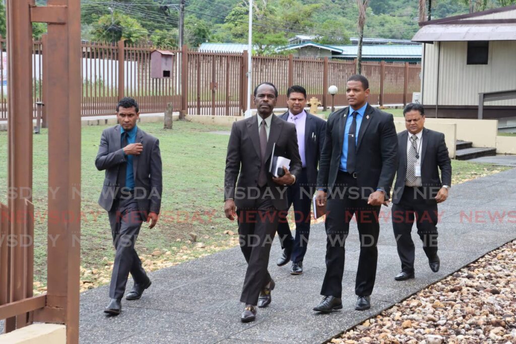 centre, Fitzgerald Hinds, Minister of National Security accompanied by Senior Superintendent Rishi Singh;head of Homicide Unit of TTPS and director at Forensic Science Centre, Derrick Sankar accompanied with his security detail - ROGER JACOB