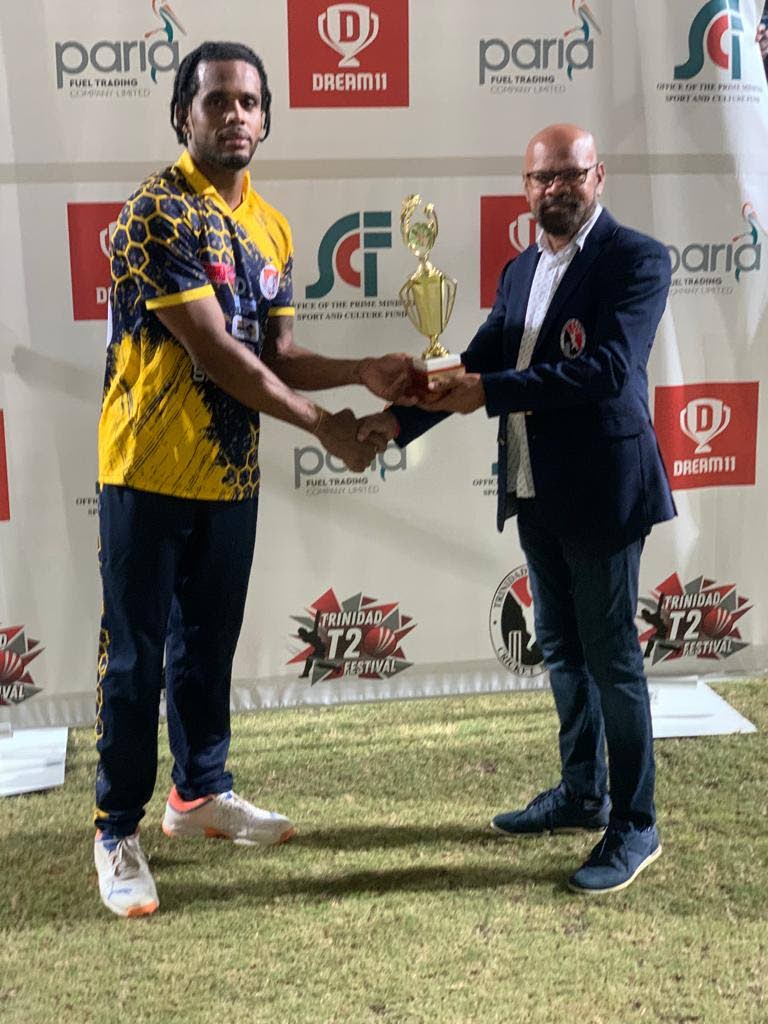 Kjorn Ottley of Central Sports, left, receives the player of the match award from TT Cricket Board treasurer Kiswah Chaitoo. - courtesy TT Cricket Board