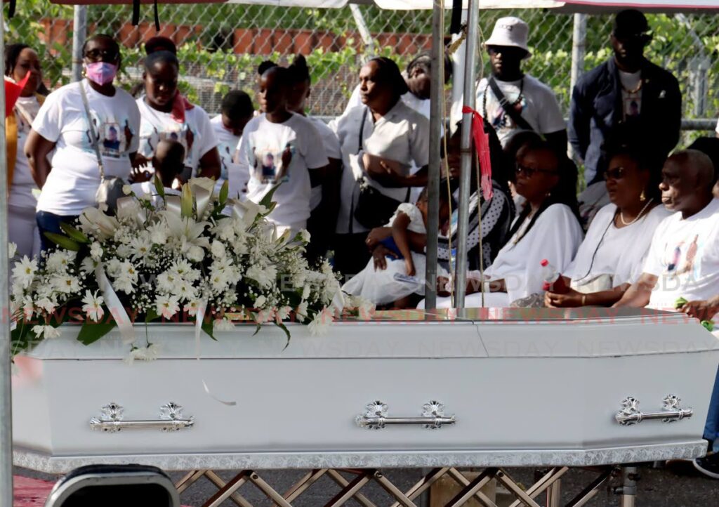 A casket containing the body Kisseh Lendor at his funeral at the Haig Street Basketball Court, Carenage on Monday. Lendor was fatally shot by police in Chaguanas on May 16. - ROGER JACOB