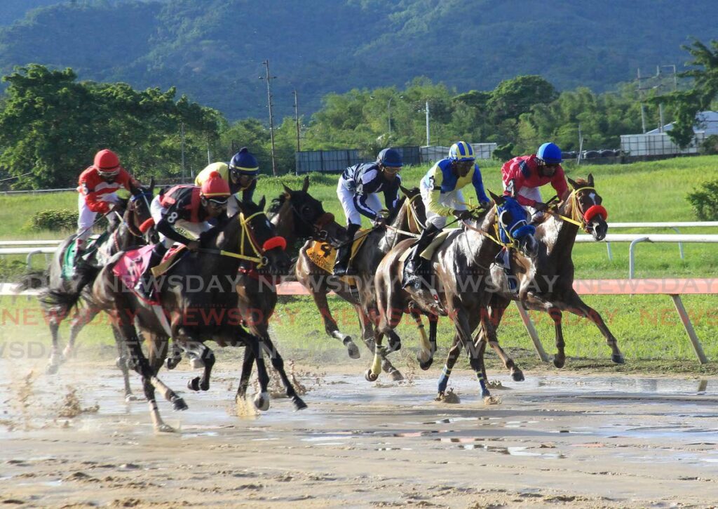 Jockey Tristan Phillips, far right, rides In the Headlines to victory in the Guineas race at the Arima Race Club, Santa Rosa, Tuesday.  - AYANNA KINSALE