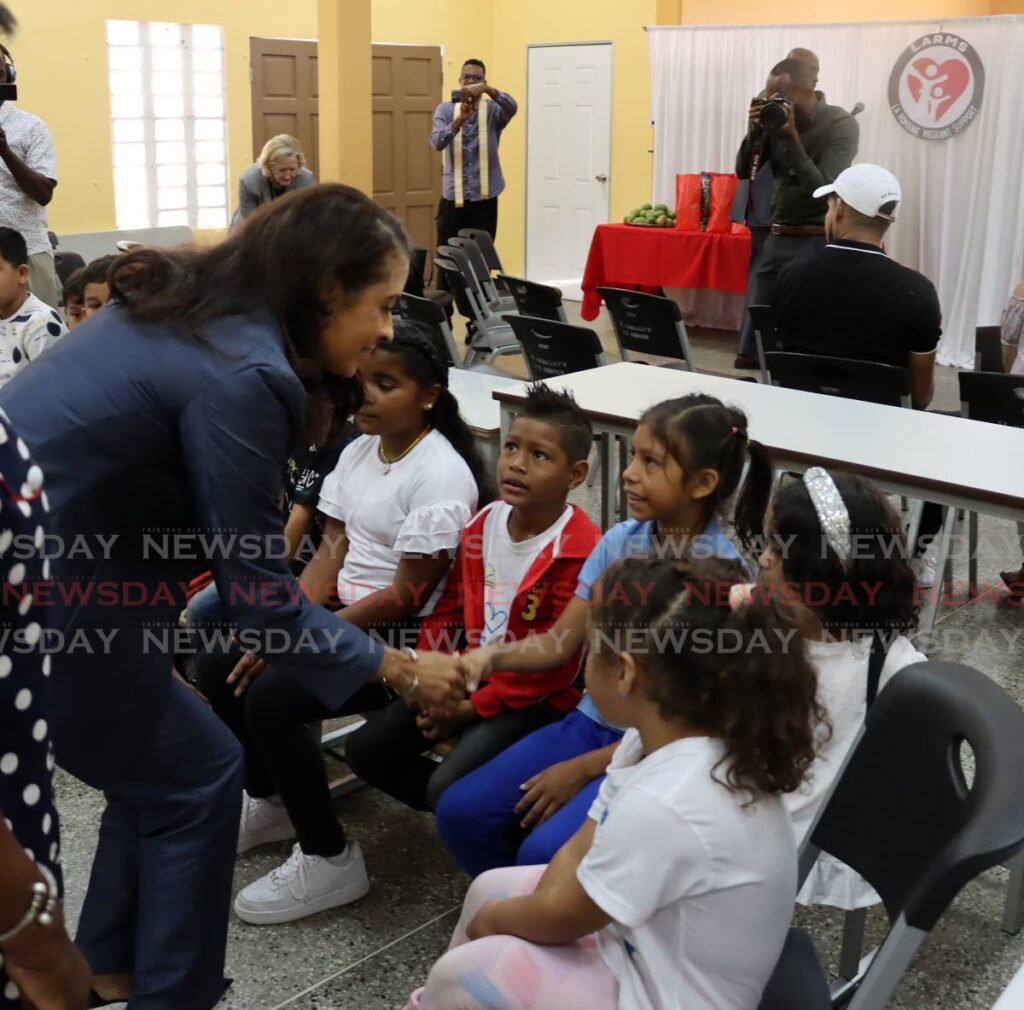 United States Ambassador Candace Bond greets the children attending the migrant school at LARMS. - Photo by Roger Jacob