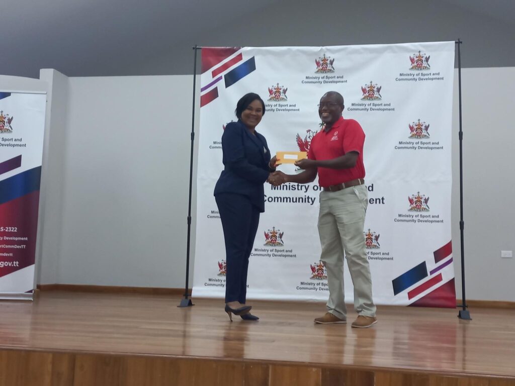 Minister of Sport Shamfa Cudjoe presents funding to Special Olympics TT director Ferdinand Bibby. PHOTO COURTESY SPECIAL OLYMPICS TT 