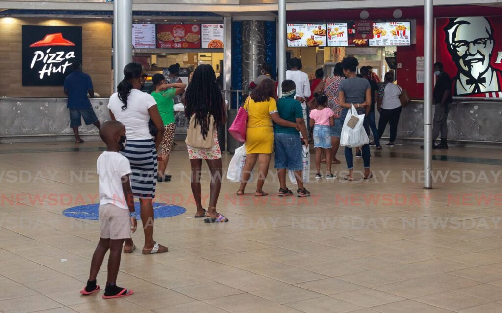 Customers line up for fast food at Gulf City Mall, Lowlands.  - David Reid