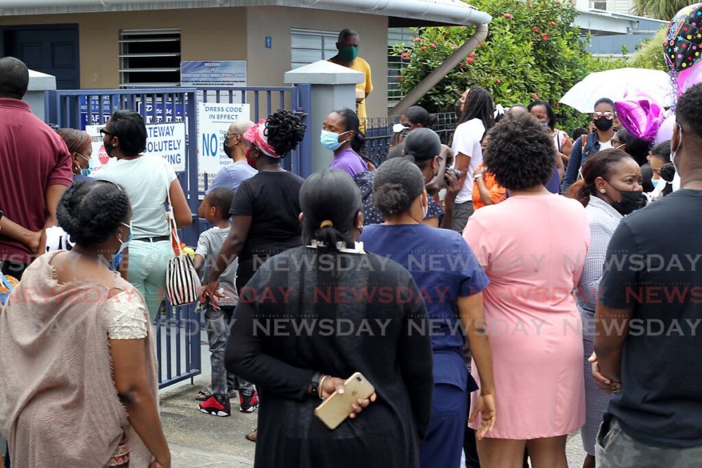 Parents wait outside Sacred Heart Girls' RC School, Port of Spain for their children who wrote the SEA exam on March 31. - ROGER JACOB