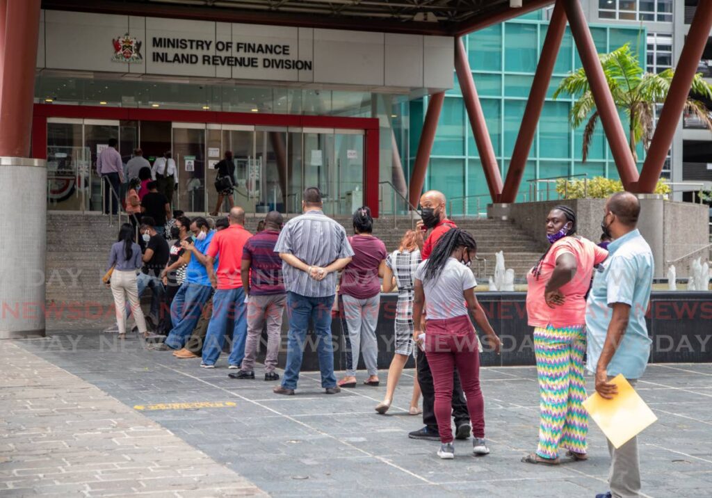 People line up to file tax returns at the Inland Revenue Division, Port of Spain. The Inland Revenue division and Customs and Excise Division are to be restructed under the TT Revenue Authority. - FILE PHOTO/JEFF K MAYERS