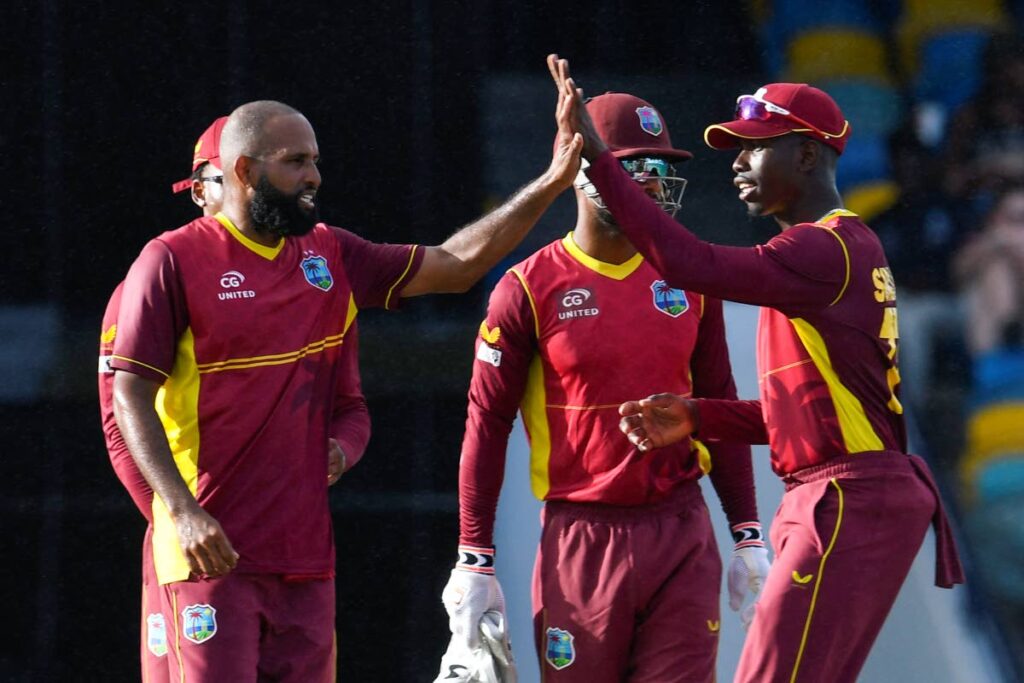 Spinners Yannic Cariah (left) and Kevin Sinclair (right) of the West Indies celebrate a wicket. FILE PHOTO - 