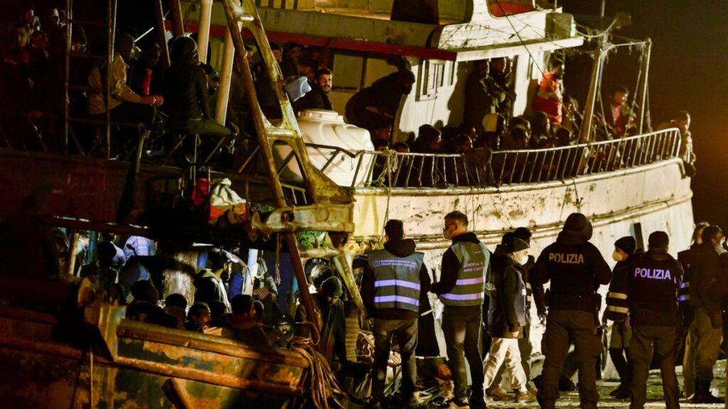Police check a fishing boat with some 500 migrants in the southern Italian port of Crotone, early on March 11. The Italian coast guard was responding to three smugglers boats carrying more than 1,300 migrants off Italy’s southern coast. AP Photo - 