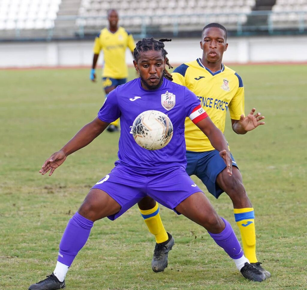 AC Port of Spain's Duane Muckette shields the ball in a TT Premier Football League match vs Defence Force earlier this season. - Photo courtesy TT Premier Football League 