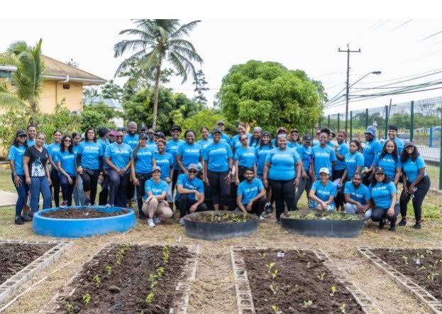 Nigel Baptiste, managing director and president, Republic Bank among the troop of cheerful volunteers that worked to rehabilitate the garden at the Couva Children’s Home and Crisis Nursery. - 