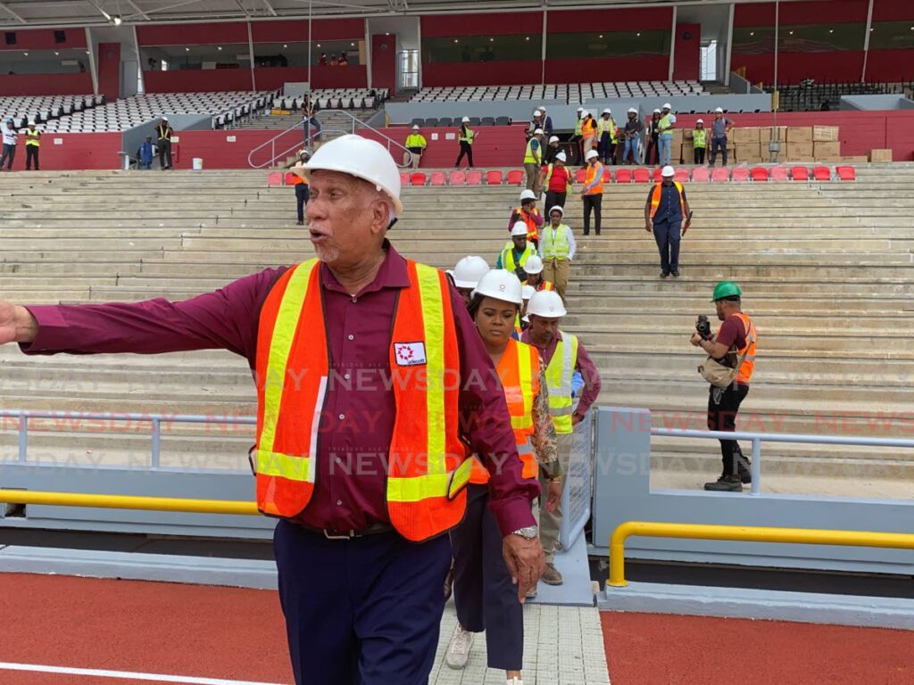 Udecott chairman Noel Garcia shows the restored track at the Hasely Crawford Stadium to officials including the Prime Minster and Minister of Sport Shamfa Cudjoe  - Narissa Fraser
