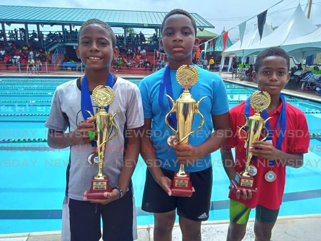 Micah Alexander, centre, won the boys 8-9 competitive division ahead of Macrus Nesbitt and Zakai Victor, who were joint second, at Sunday's National Primary Schools Swim Meet, Centre of Excellence, Macoya. - Stephon Nicholas