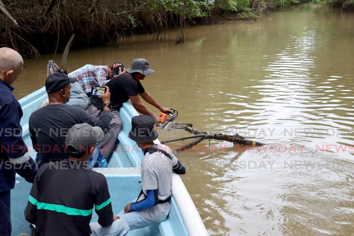 Volunteers clean river to fight Woodland flooding - Trinidad and Tobago ...