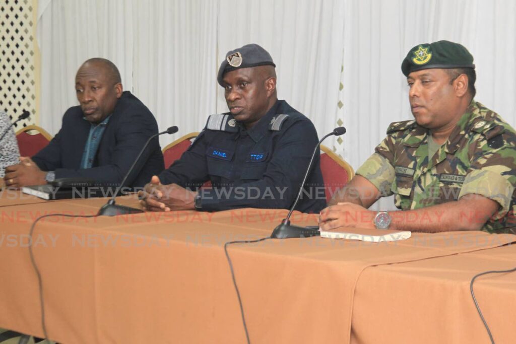 Chief of Defence Staff, Air Vice Marshal Darryl Daniel, centre, speaks during a press conference at the Ministry of National Security, Temple Court, Abercromby Street, Port of Spain, on Sunday, while  Deputy Commissioner of Police Investigations and Intelligence (ag) Curt Simon, left, and TT Regiment acting head Lt Col Ashook Singh look on. - AYANNA KINSALE