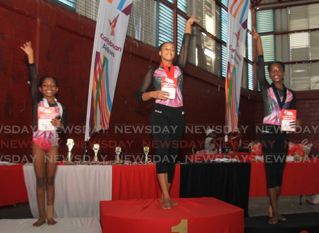 Michaela Francis, centre, placed first in the level seven category, Annaleigh Edwards, second, and Annalise Alexander of Olympia Gynastics Wolfpack, third during the TT Gymnastics Federation Annual National Invitational Championshipsat at the Woodbrook Youth Facility. 