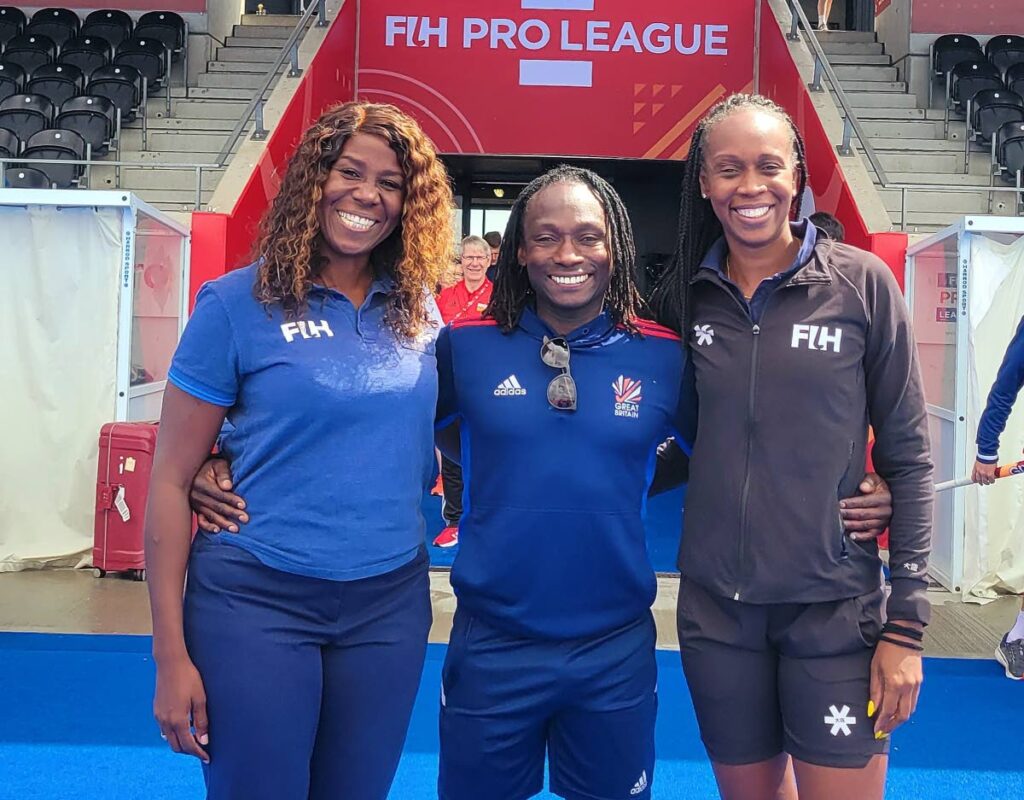 Hockey coach Kwandwayne Browne, centre, with officials Ayanna McClean, right, and Reyah Richardson, at the FIH Pro League in London, England recently. - 