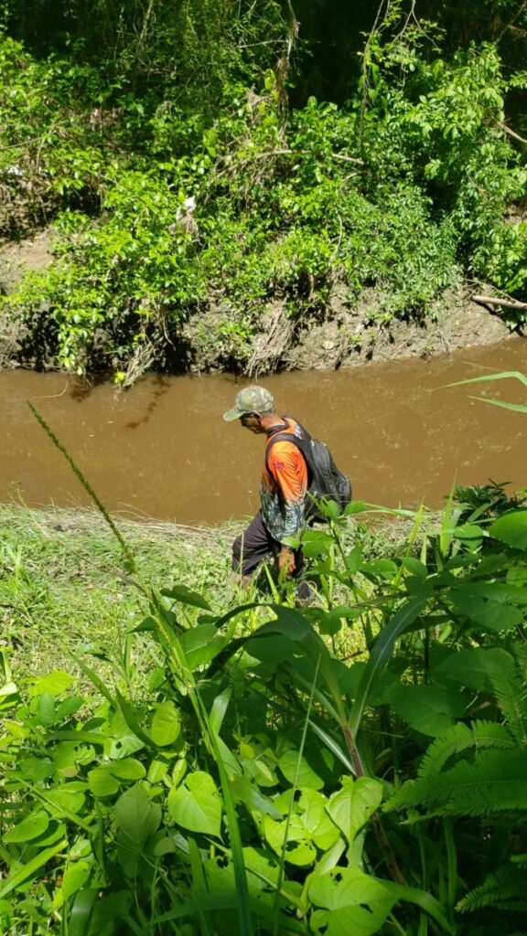 Hunters Search and Rescue Team leader  Vallence Rambharat searched for a jaguar in  Palo Seco on Tuesday. PHOTO COURTESY HUNTERS SEARCH AND RESCUE TEAM. - 