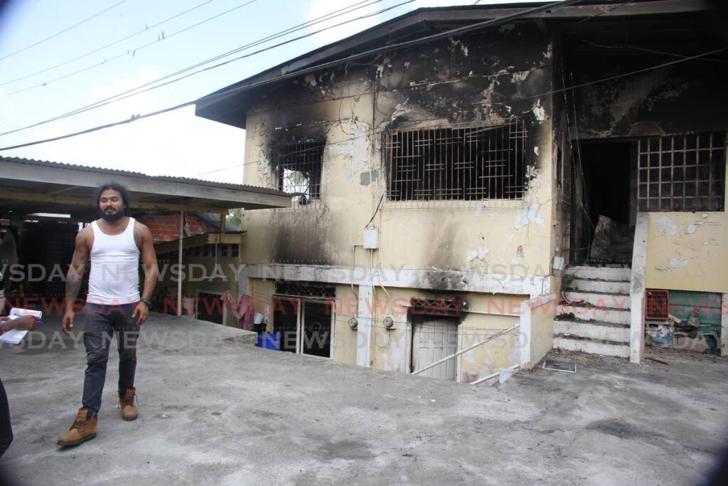 Marcus Jennings speaks to Newsday outside his La Plaisance Road, La Romaine, home which was destroyed by fire on Wednesday. The fire left eight people homeless. - Lincoln Holder