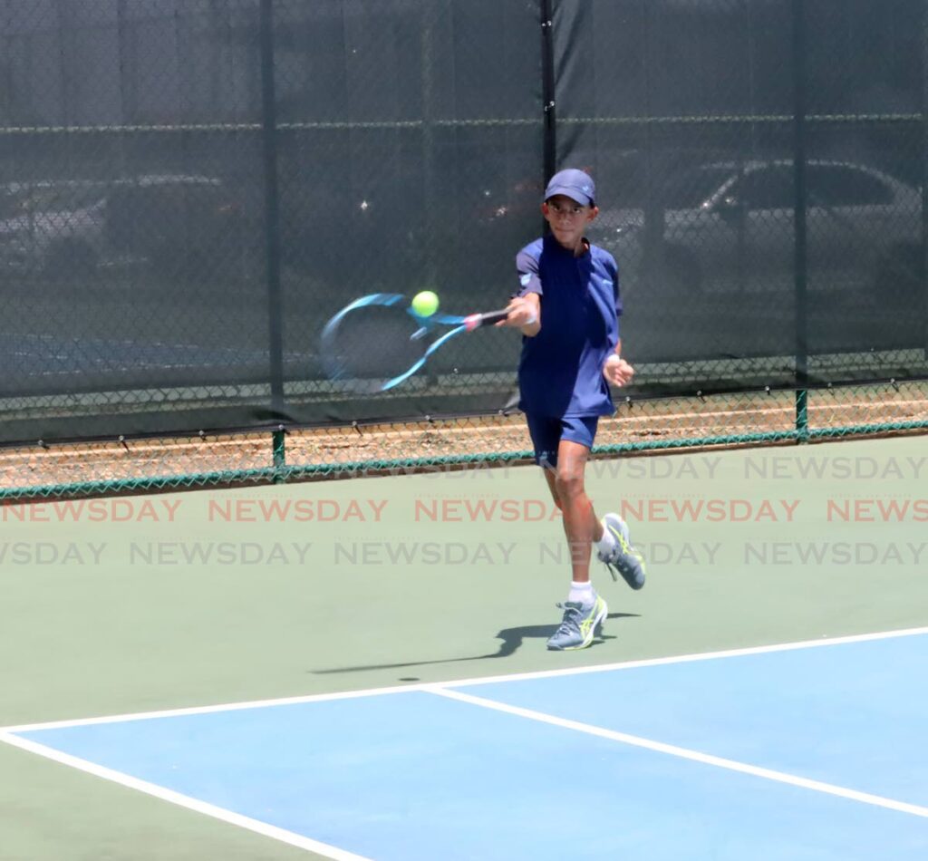 Christopher Khan competes in the Boys' Under-14 singles match, on Thursday, at the Lease Operators Ltd's Junior Tennis Tounrnamentt, at the National Racquet Centre, Tacarigua.  - ROGER JACOB