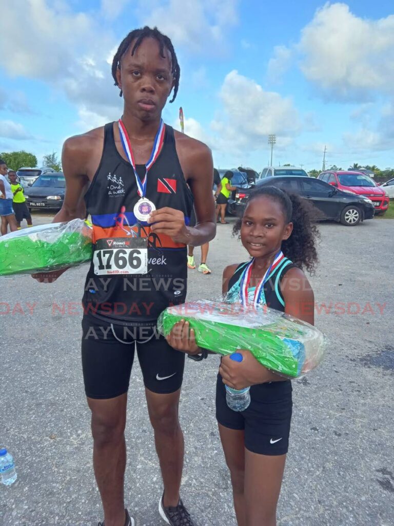 Joshaun Collier, left, and Chennai Moore were crowned Sweaters 5K male and female overall winners on Thursday at the Ojoe Road Recreation Ground, Sangre Grande.  - Stephon Nicholas