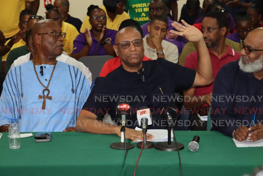 JTUM leader Ancel Roget, centre, halts members from singing during a media conference on Labour Day celebrations at BIGWU's office in Barataria. At left is NATUC general secretary Michael Annisette. - ROGER JACOB