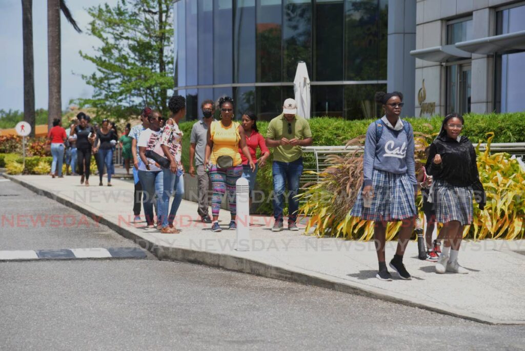 Schoolchildren walk along a roadway. - File photo by Anisto Alves