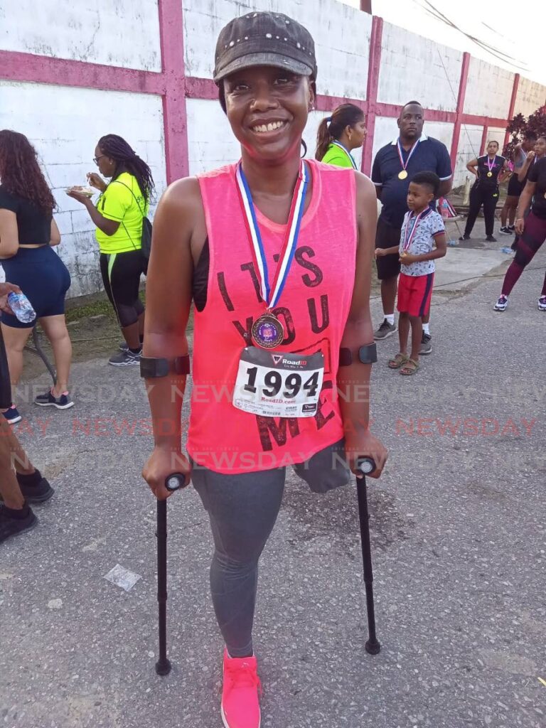 Christabell Drayton with her medal after completing the annual Sweaters 5K Fun Run and Walk on Thursday in Sangre Grande.  - Stephon Nicholas
