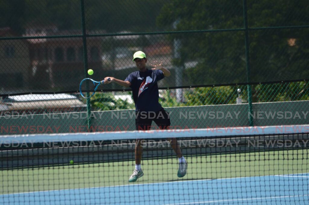 Brian Harricharan plays a shot in the Boys' 14 and Under singles quarter-final match aganist Connor Carrington at the Lease Operators Ltd Junior Tennis Tournament at the National Racquet Centre, Tacarigua on Saturday. - Anisto Alves