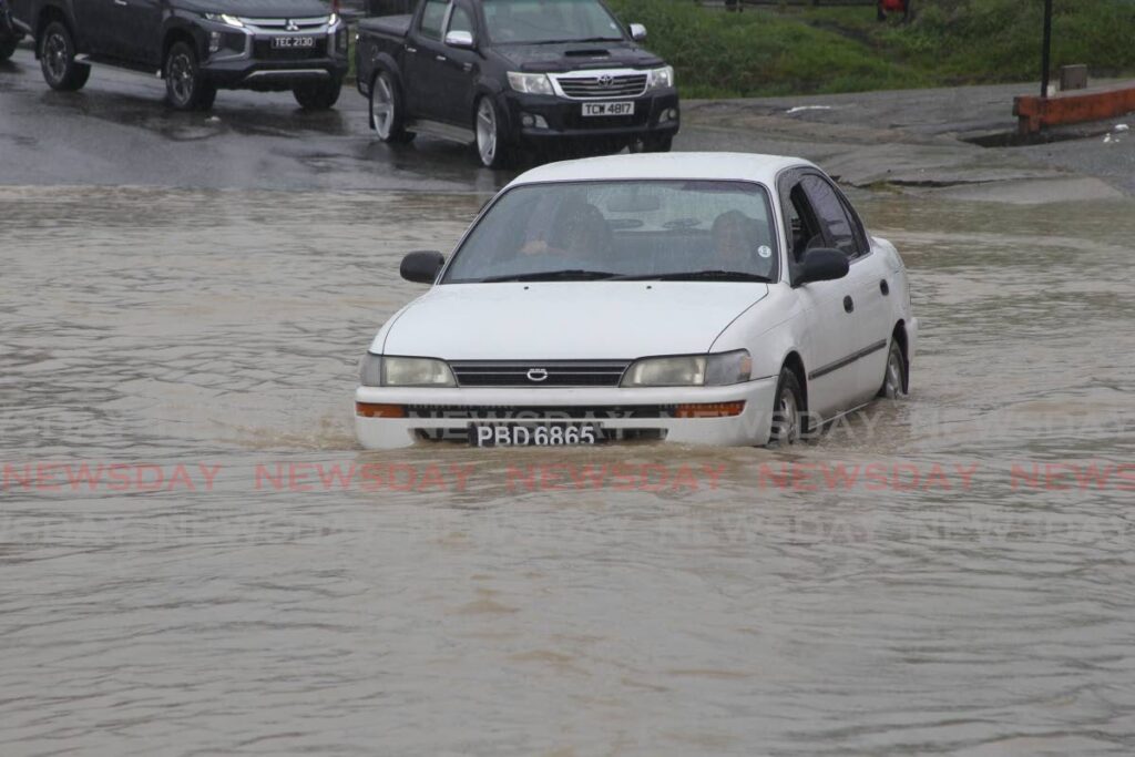 In this file photo this driver proceeded slowly through this floodwater. -