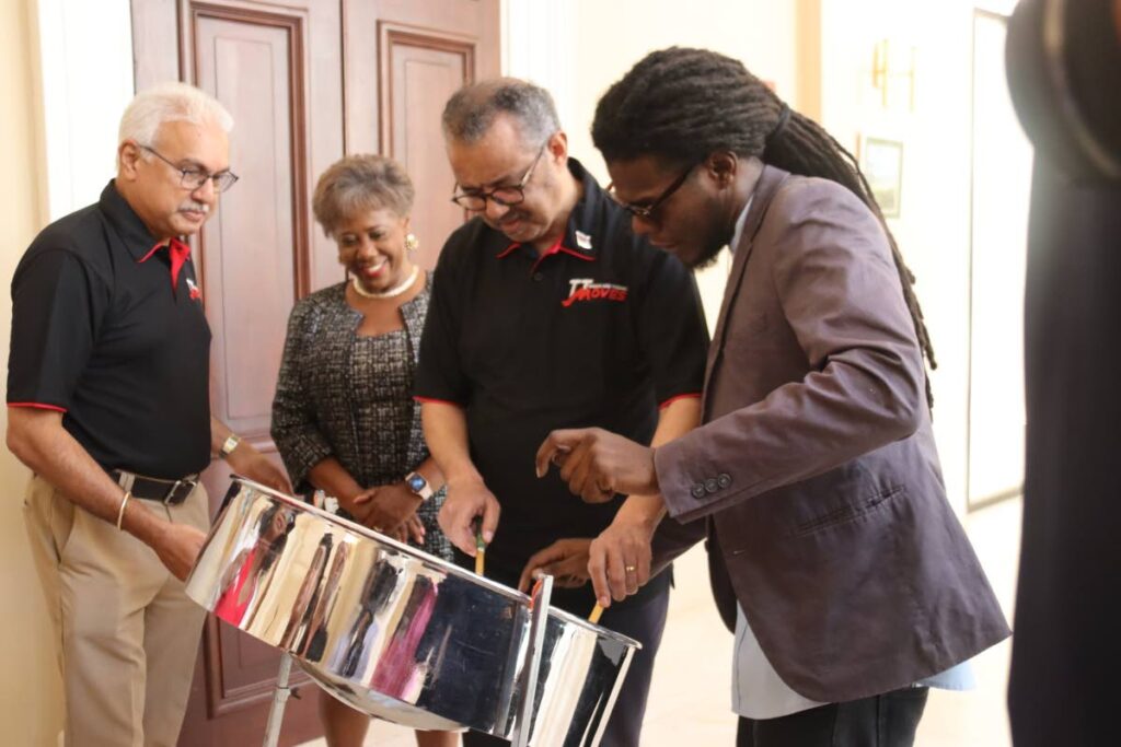 WHO Director General Dr Tedros Adhanom Ghebreyesus learns to play the steelpan while  Health Minister Terrence Deyalsingh and Speaker Brigid Annisette-George look on during a visit to the Red House on Friday. Photo courtesy the Ministry of Health. - 