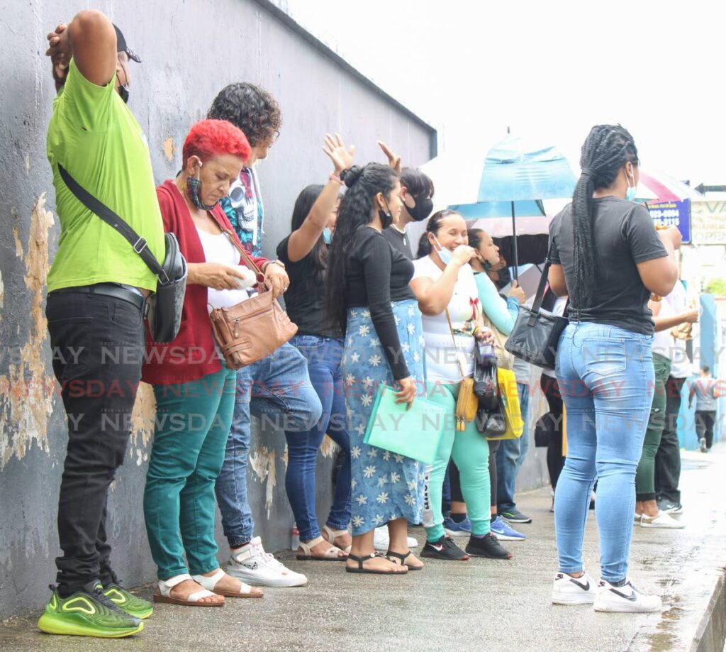 Three different groups of Venezuelans arrived at Immigration on Henry St, Port of Spain on Monday to process their legal documents. - Photo by Grevic Alvarado