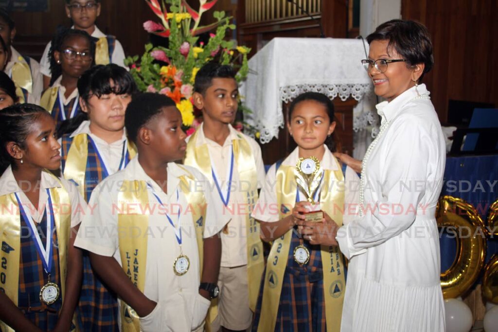 President Christine Kangaloo chats with graduates of her almer mater Grant Memorial Presbyterian School at its gruaduation at The Susamachar Presbyterian Church, San Fernando, on Friday. - Lincoln Holder