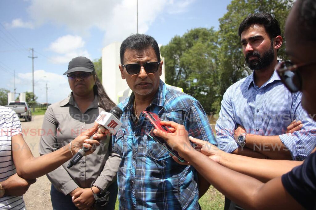 Works and Transport Minister Rohan Sinanan speaks to the media, alongside director of the drainage division Katherine Badloo-Doerga and minister in the ministry Richie Sookai at the Tulsa Trace pump site in Penal on Saturday. - Lincoln Holder