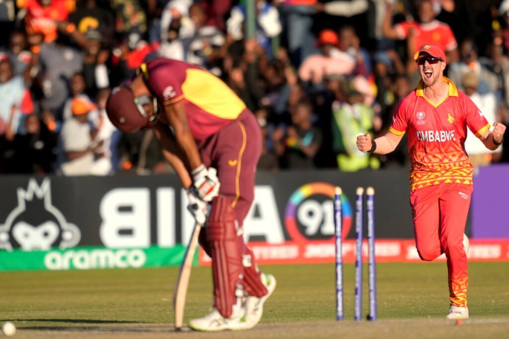 Zimbabwe player Bradley Evans celebrates the wicket of West Indies batsman Roston Chase during their ICC Men's Cricket World Cup Qualifier match at Harare Sports Club in Harare, Zimbabwe, on Saturday. - AP PHOTO