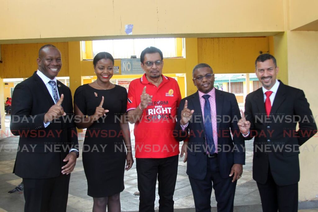 Minister of Agriculture Kazim Hosein, centre, with PNM local government candidates, from left, Nigel Couttier, Teresa Lynch, Robert Parris and Marcus Girdharie at Pleasantville Plaza, on Monday. - Lincoln Holder