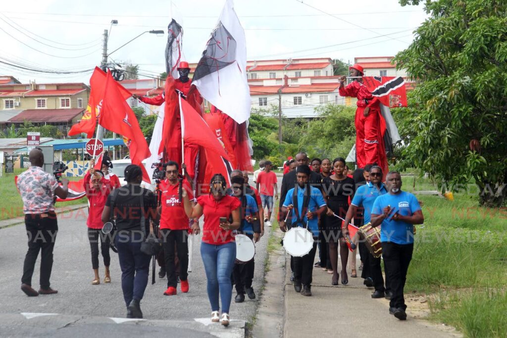 PNM Local Government candidates on their way with supporters to file nomination papers at the Pleasantville  Secondary School.  - Photo by Lincoln Holder