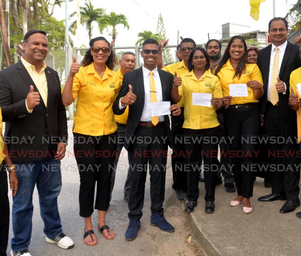 UNC local government candidates, from third from left, Richard Rampersad, Seema Ramsaran-Augustine and Kamla Phagoo celebrate with supporters at the UTT  Valsayn Campus, after filing their nomination papers on Monday. Also in the photo are, from left, MPs Dr Rishad Seecheran, Khadijah Ameen and Dinesh Rambally. - Anisto Alves