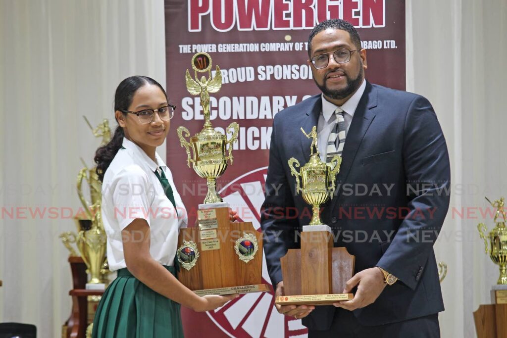 A Rio Claro West Secondary School player collects a trophy from Powergen communications manager Francois Ottley (R) during the Powergen Secondary Schools Cricket League awards ceremony, on Wednesday, at the Couva /Point Lisas Chamber Building, Couva. Rio Claro West won the 2023 girls intercol T20 title. - Lincoln Holder