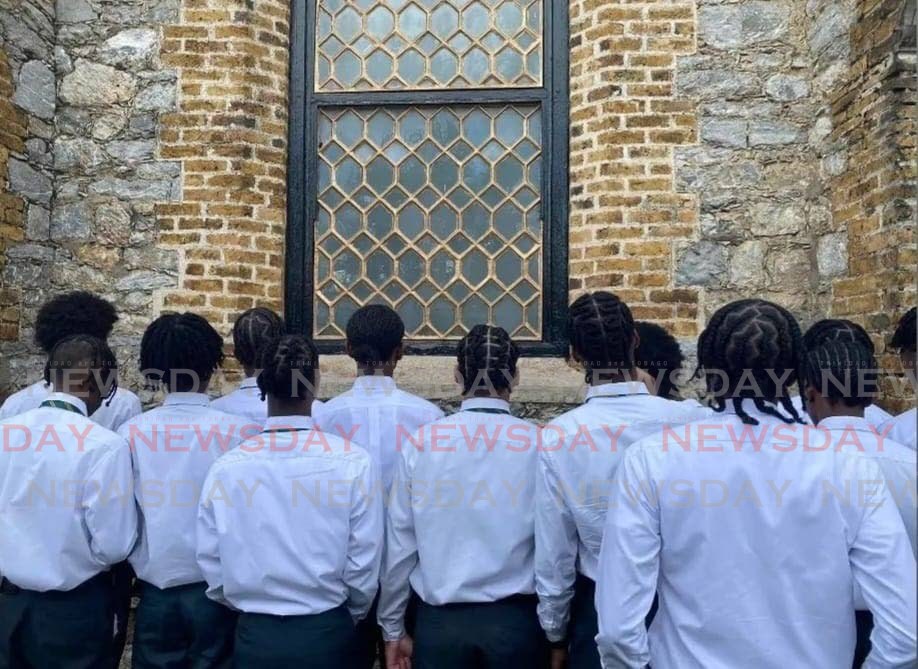 Trinity College, Moka, students stand outside their graduation ceremony at All Saints Church, Marli Street, Port of Spain, on Tuesday. - 
