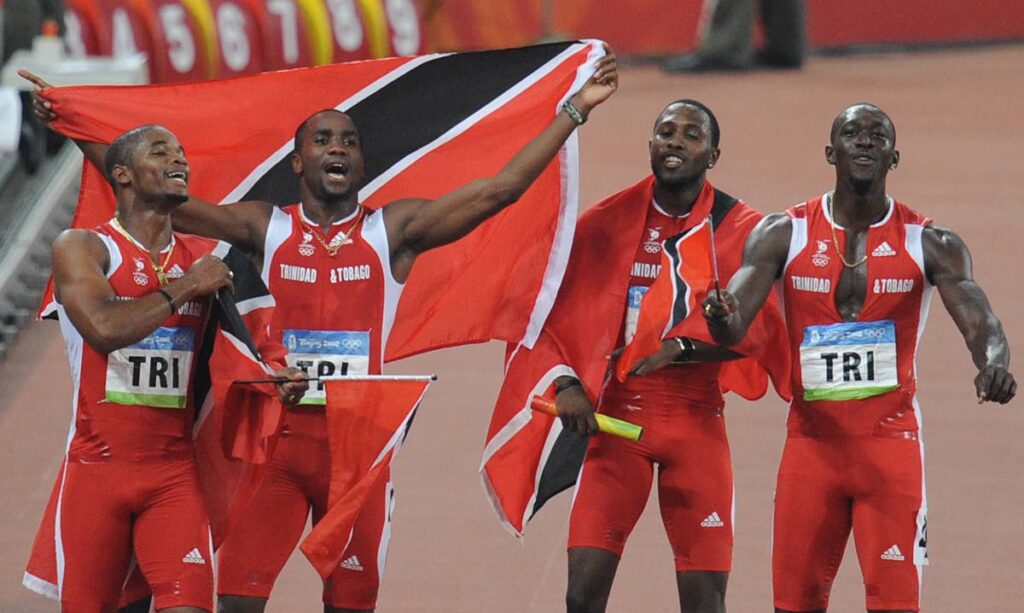 TT's relay men (from left) Keston Bledman, Emmanuel Callender, Richard Thompson and Marc Burns celebrate after taking silver in the men's 4×100m relay final at the National Stadium during the 2008 Beijing Olympic Games on August 22, 2008. - 