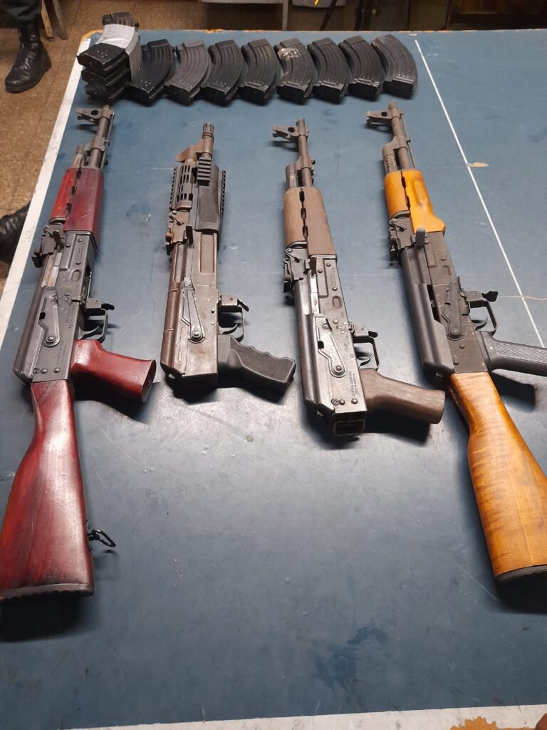 Four guns and magazines, seized by police in Debe, on display at Marabella Police Station on Saturday. - Photo courtesy TTPS