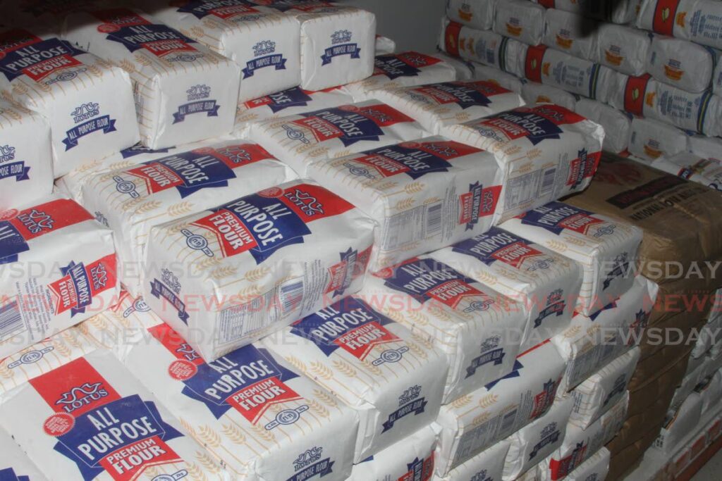 Bags of NFM All Purpose Flour stack the shelves at Xtra Foods Supermarket, Xtra Plaza, Chaguanas on Wednesday. - Photo by Angelo Marcelle