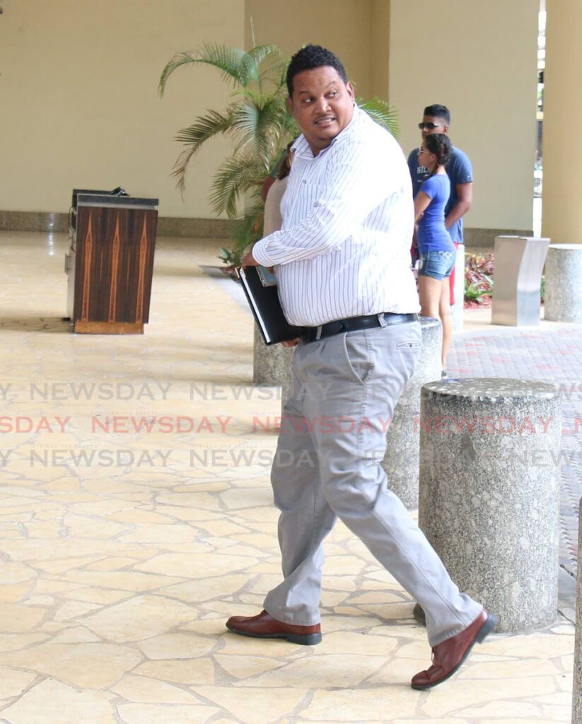 Darryl Smith as minister of sport heads to a meeting in 2015. - File photo/Angelo Marcelle