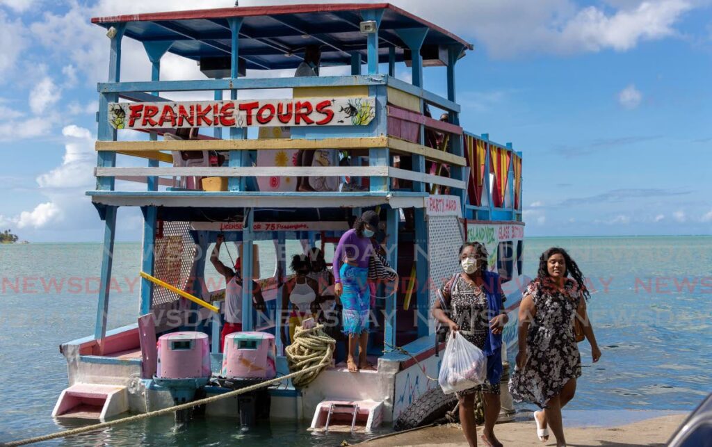 Visitors exit the Frankie Tours glass-bottom boat after a trip to the Buccoo Reef, Nylon Pool and No Man’s Land. - David Reid