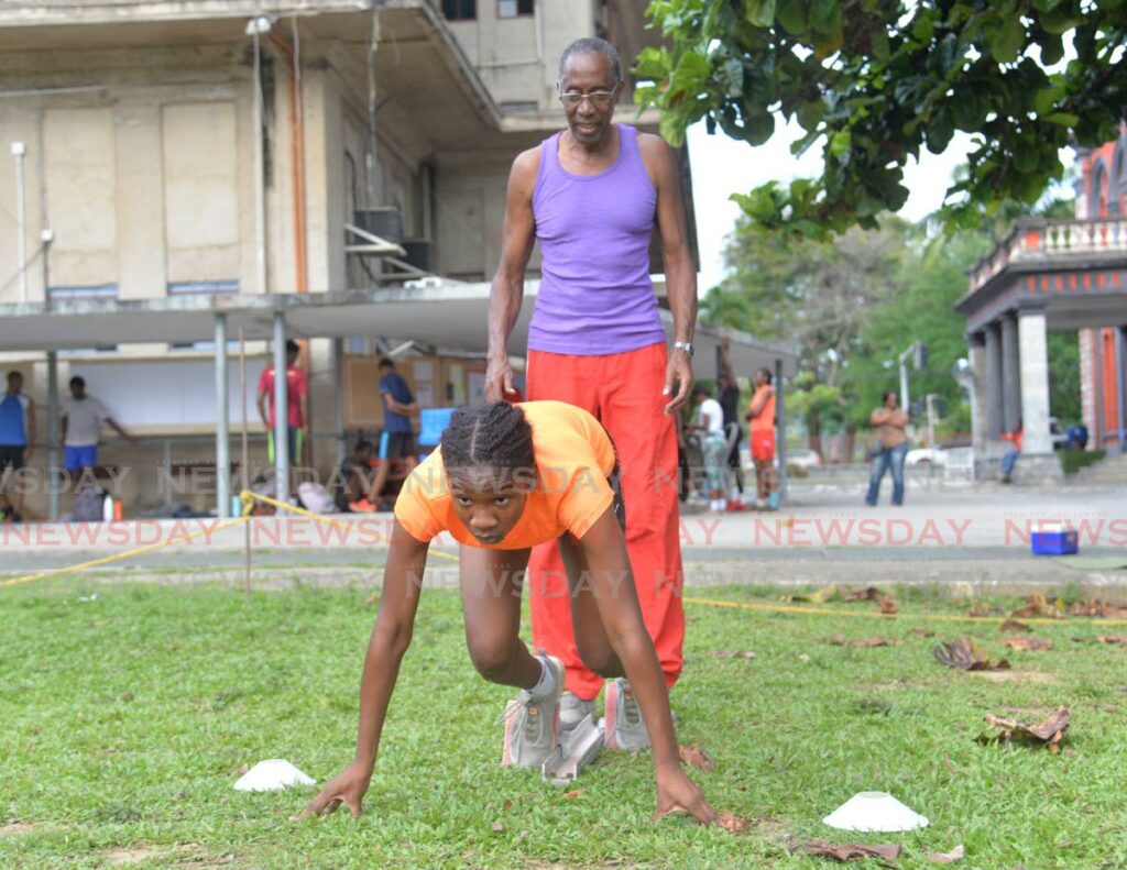 In this file photo, TT’s Janae De Gannes trains with her club Concorde Athletics at the Queen’s Royal College Grounds, Port of Spain. Looking on is club coach Ken Barton. - Photo by Anisto Alves